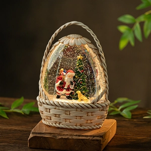 Christmas musical snow globe featuring Santa and golden retriever in basket lantern