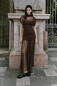 Detailed view of the brown mesh maxi dress featuring elegant pleated waist design