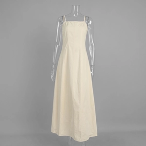 Detail of high-waist cream cotton maxi dress featuring thin straps and clean stitching