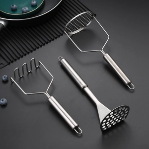 Three stainless steel potato mashers with different heads on a dark matte surface