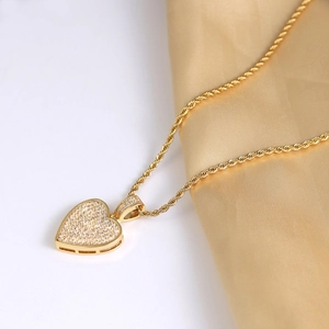 Hip hop style gold heart pendant necklace with shimmering cubic zirconia and twist chain