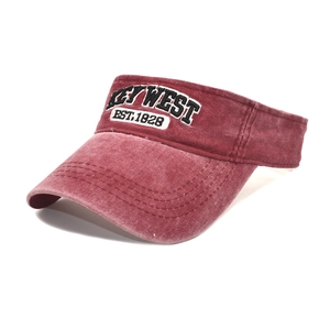 Detail of embroidered Key West logo on dark red washed denim sun visor hat