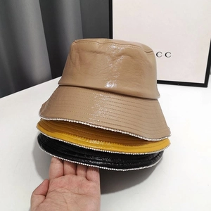 Detail showing shiny PU leather texture and silver rhinestone chain trim on these bucket hats
