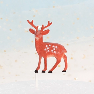 Christmas reindeer cake topper with cute spotted deer design on dreamy blue background
