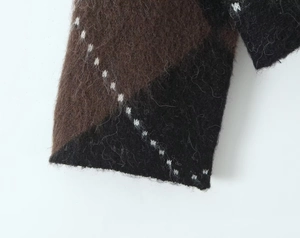 Detailed macro view of checkered knit mohair sweater with long plush fiber textures