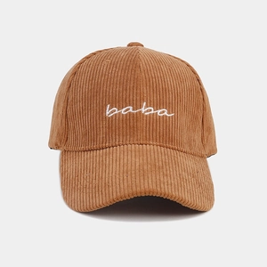 Detailed view of the brown corduroy baseball cap with white baba embroidery on the front