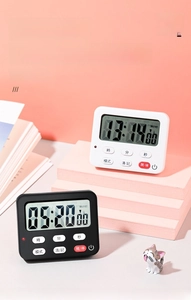 Digital kitchen timer with LCD screen and physical buttons on a decorative display stand
