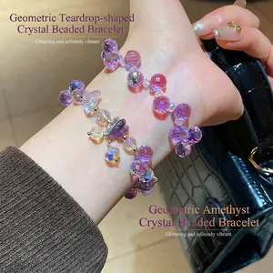 Elegant purple faceted amethyst beaded bracelet with golden accents and crystal charms