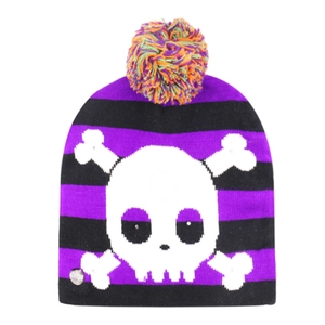 Detail of Halloween LED knitted hat with purple stripes, white skull, and ON/OFF switch