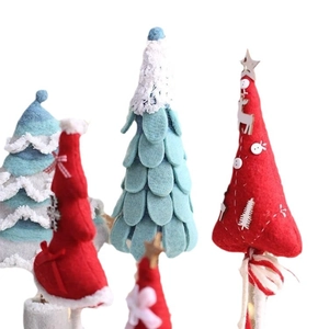 Handmade wool felt Christmas tree ornaments in red and light blue colors on white base