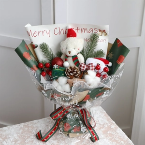 Detailed view of Christmas bouquet with teddy bear, Santa doll, pine cones and red berries