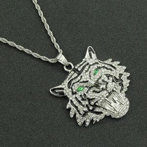 Silver full diamond tiger head pendant necklace with green eyes on black background
