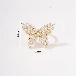 Detailed view of butterfly ring with zircon stones, measuring 2.4cm by 1.8cm