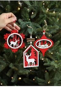 Detail of laser-cut wooden Christmas ornaments with reindeer and snowflake patterns
