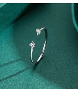 Macro detail of 925 sterling silver open ring featuring two small round moissanite stones