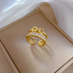 Detail of gold-plated bow ring with sparkling zircons placed in a luxury jewelry box