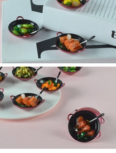 Macro shot of miniature dollhouse frying pans with realistic resin food on white plates