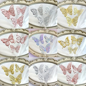 Assorted colorful hollow paper butterfly cake toppers in gold silver and pink finishes