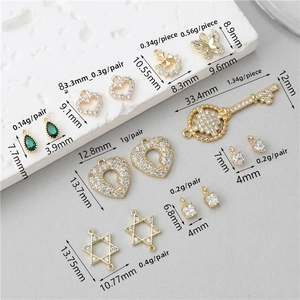 Macro detail of gold-plated zircon charms with precise size and weight measurements