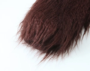 Macro detail of dense dark brown faux fur knit coat showing soft texture and glossy finish