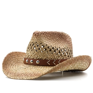 Detail of western straw hat featuring hollow weave and leather band with metal rivets