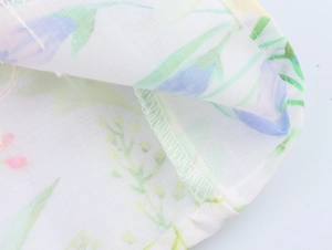 Macro shot of floral pattern fabric with precise stitching and breathable texture