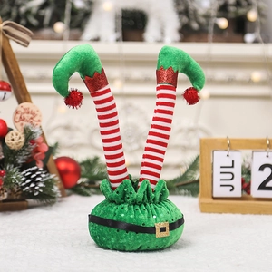 Cartoon Christmas elf legs decoration with red white stripes for festive tabletop display