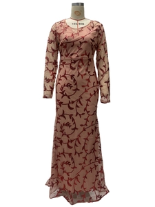 Detail of sequined vine patterns on a mesh mermaid evening gown with long sleeves