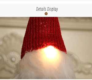 Close-up of a Christmas gnome featuring a red sequin knit hat and glowing warm light nose