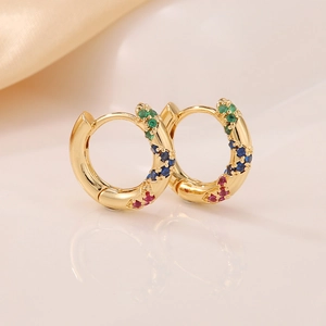 Minimalist gold huggie earrings with colorful zircon stones in a wavy pave setting