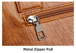 Close-up of premium brown litchi pattern leather and gunmetal hardware zipper puller