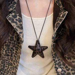 Close-up of leopard print starfish pendant necklace worn by a model in a retro style