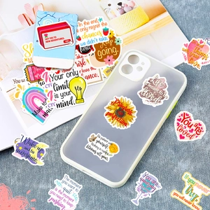 Close-up of waterproof inspirational stickers on a phone case and magazine with clear details