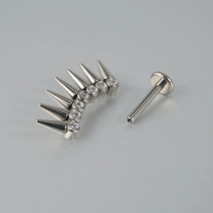 Macro shot of G23 titanium labret stud with silver spikes, clear zircons and threaded bar