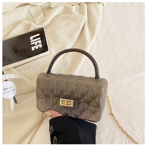 Deep gray transparent jelly bag with quilted texture, beaded handle, and gold chain strap