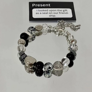 Detailed view of the beaded bracelet with leopard print charms and adjustable chain