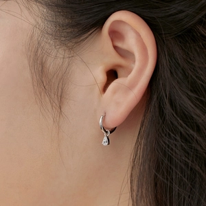 Close-up of S925 silver hoop earrings with a sparkling pear-cut zircon teardrop pendant