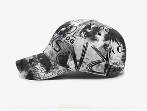 Side view of graffiti print baseball cap with street style lettering on black and white fabric