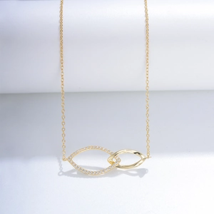 Close-up of interlocking marquise rings necklace with pavé zircon stones in gold finish