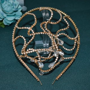 Detail of golden bridal headband with sparkling rhinestones and teardrop crystal pendants