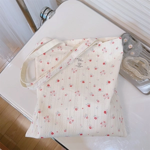 Detailed texture of cotton tote bag with floral print and minimalist brand label