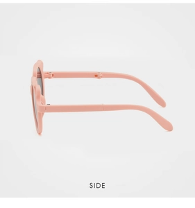 Detail view of pink foldable kids sunglasses featuring cute ears and flexible hinges