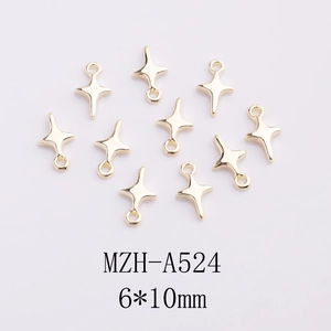 Detailed macro view of gold cross star charms size 6x10mm for DIY nail art jewelry