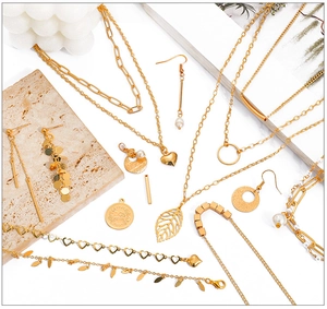 Detailed flat lay of 18K gold plated copper jewelry components with hearts and pearls