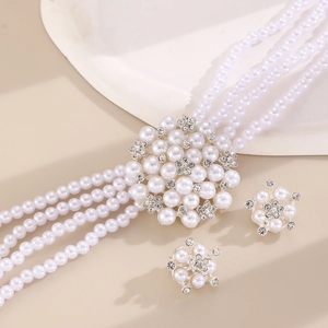 Detail of multi-layer pearl necklace with rhinestone flower pendant and matching earrings set