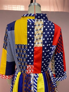 Detail view of colorful patchwork pattern with geometric prints and back zipper of the dress