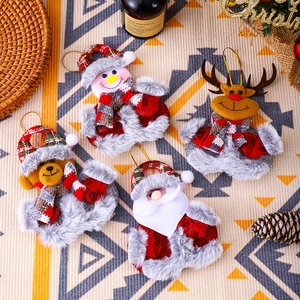 Set of four plush Christmas ornaments with Santa, Snowman, Reindeer and Bear on a festive table