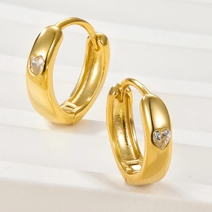 Elegant gold hoop earrings featuring heart-shaped zircon stones on a white background