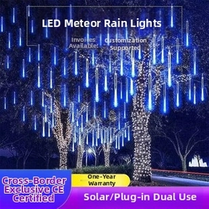 Blue LED meteor shower rain lights hanging on outdoor trees for landscape decoration