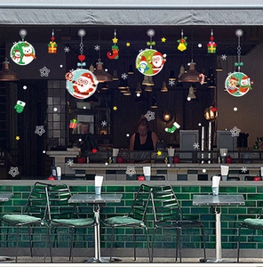 Christmas window decals with Santa Claus, reindeer and snowflakes on a dark store window